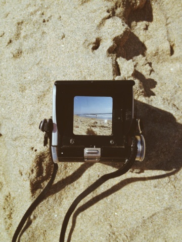old-fashioned camera in the sand